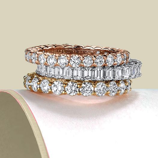 A stack of three diamond eternity rings with mixed diamond shapes and various metal types.