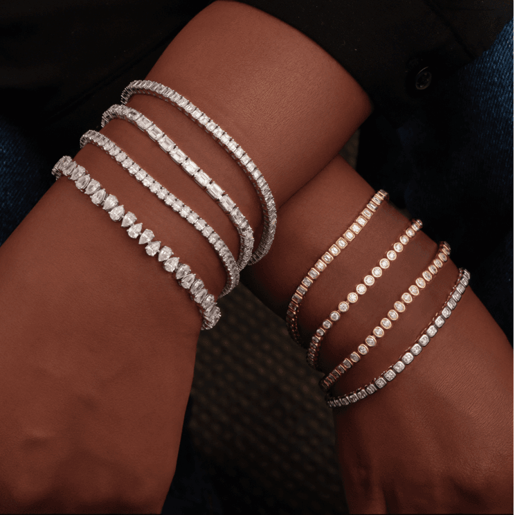 a women wearing different tennis bracelets