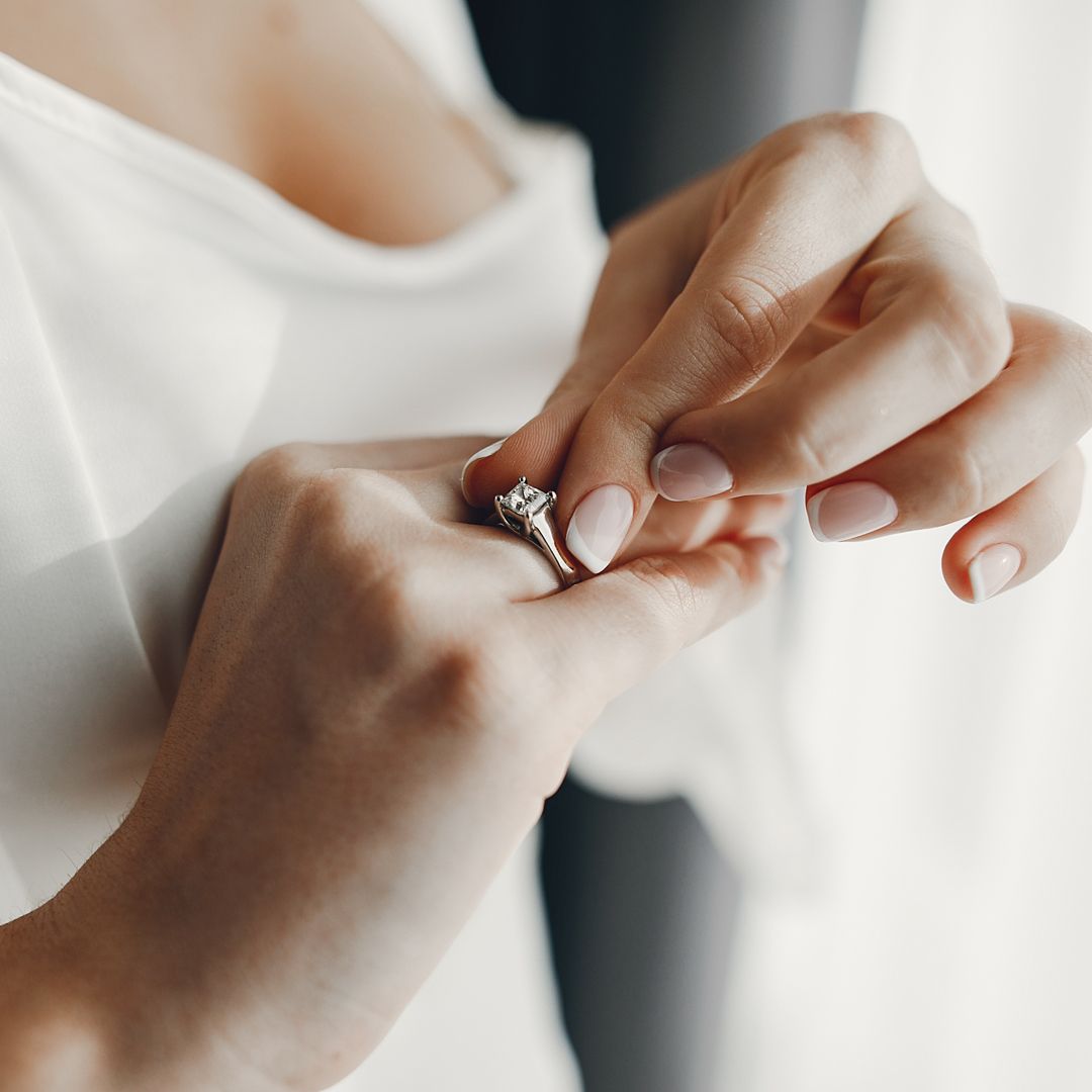 A customer trying on their engagement ring in person in a ritani showroom